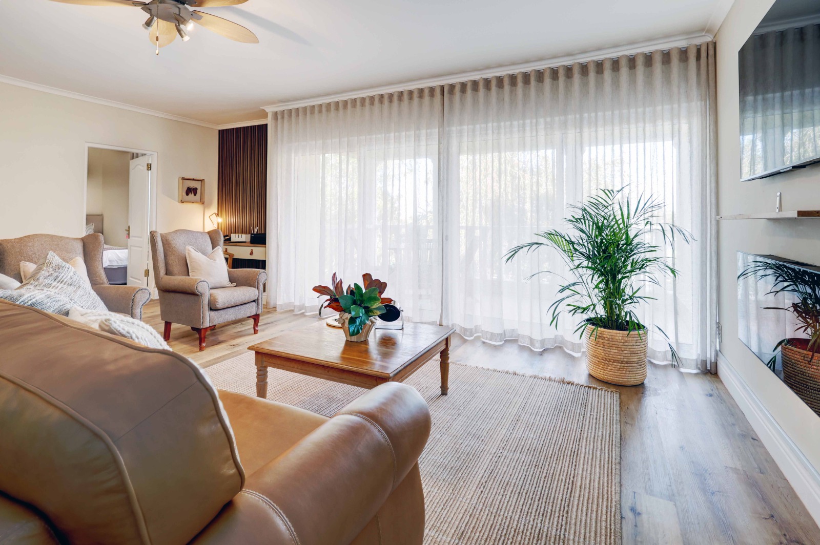 Refurbished lounge with sheer curtains — recent Cornerstone project